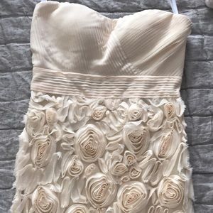 Off white strapless dress with flower detailing.